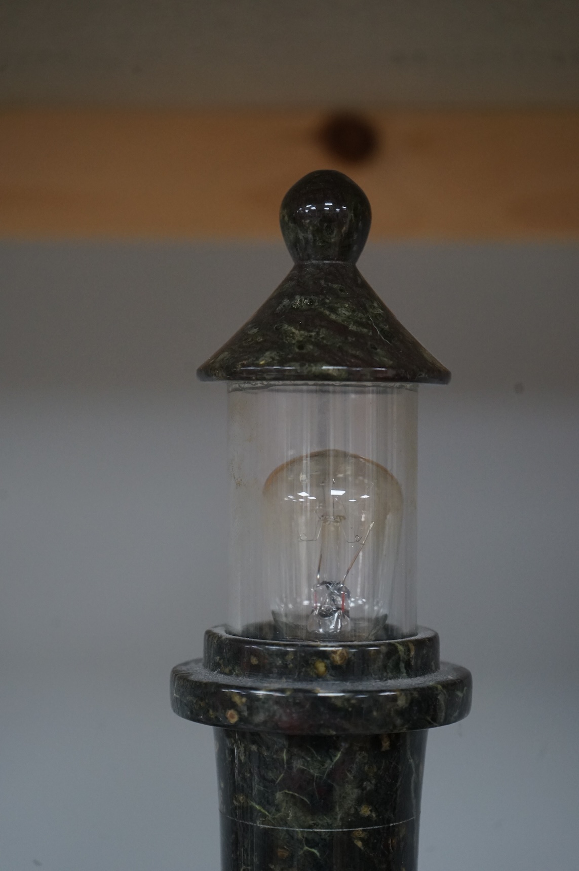 A Cornish serpentine lamp in the form of a lighthouse, 29cm high
